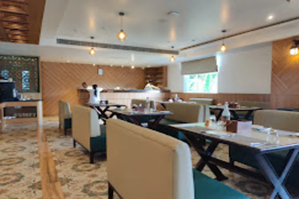 Business Hotels In Ayodhya Near Ram Mandir featuring an inviting dining area, perfect for enjoying delicious meals.