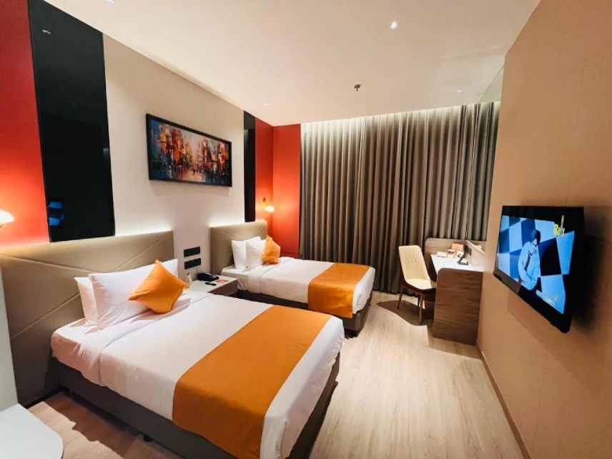 Spacious Deluxe Room at IRA by Orchid Bhavnagar featuring modern amenities, comfortable bedding, and a relaxing stay experience for business and leisure travellers